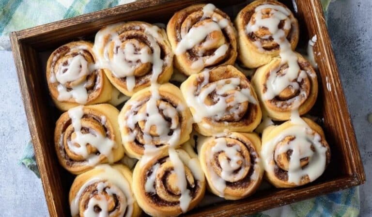 Easy Mini Cinnamon Rolls in a baking pan with glaze