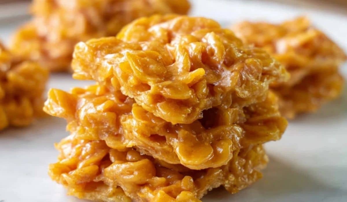 Cornflake Candy stacked in chewy golden clusters on a white plate