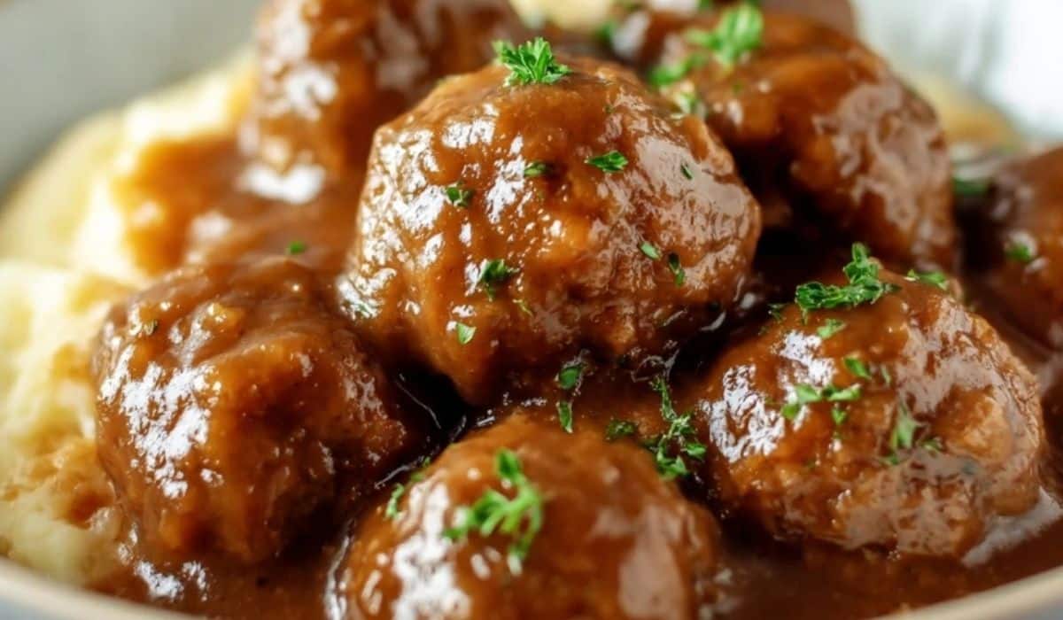 Slow Cooker Salisbury Steak Meatballs served over mashed potatoes in a bowl