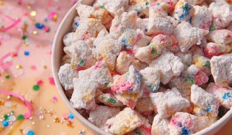 Cake Batter Puppy Chow in a bowl with rainbow sprinkles