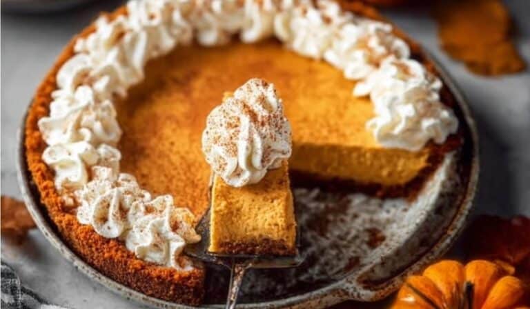 Pumpkin Cheesecake Pie on a plate with fall decor
