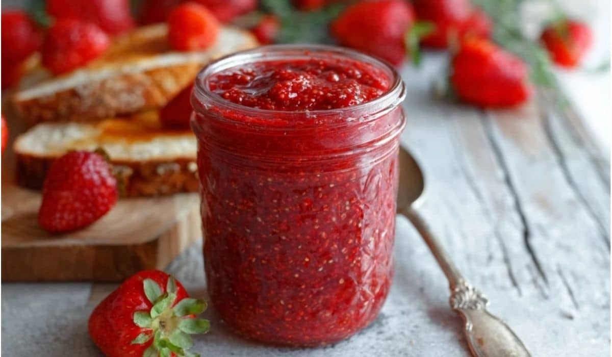 Easy 3-Ingredient Strawberry Chia Jam served in a glass jar with toast