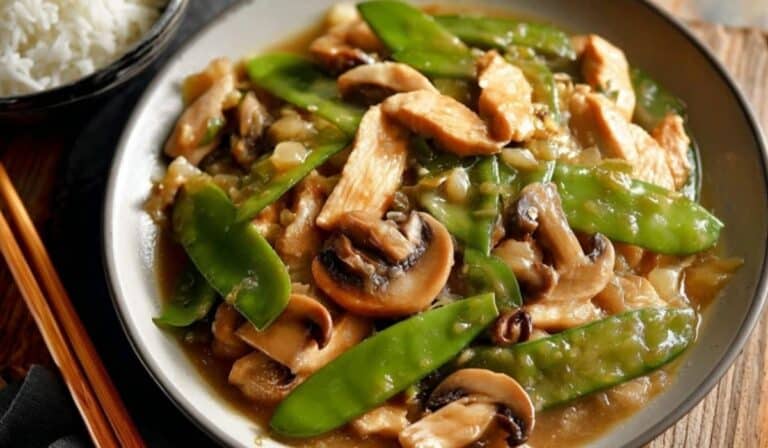 The Best Moo Goo Gai Pan served in white bowl with mushrooms and snow peas