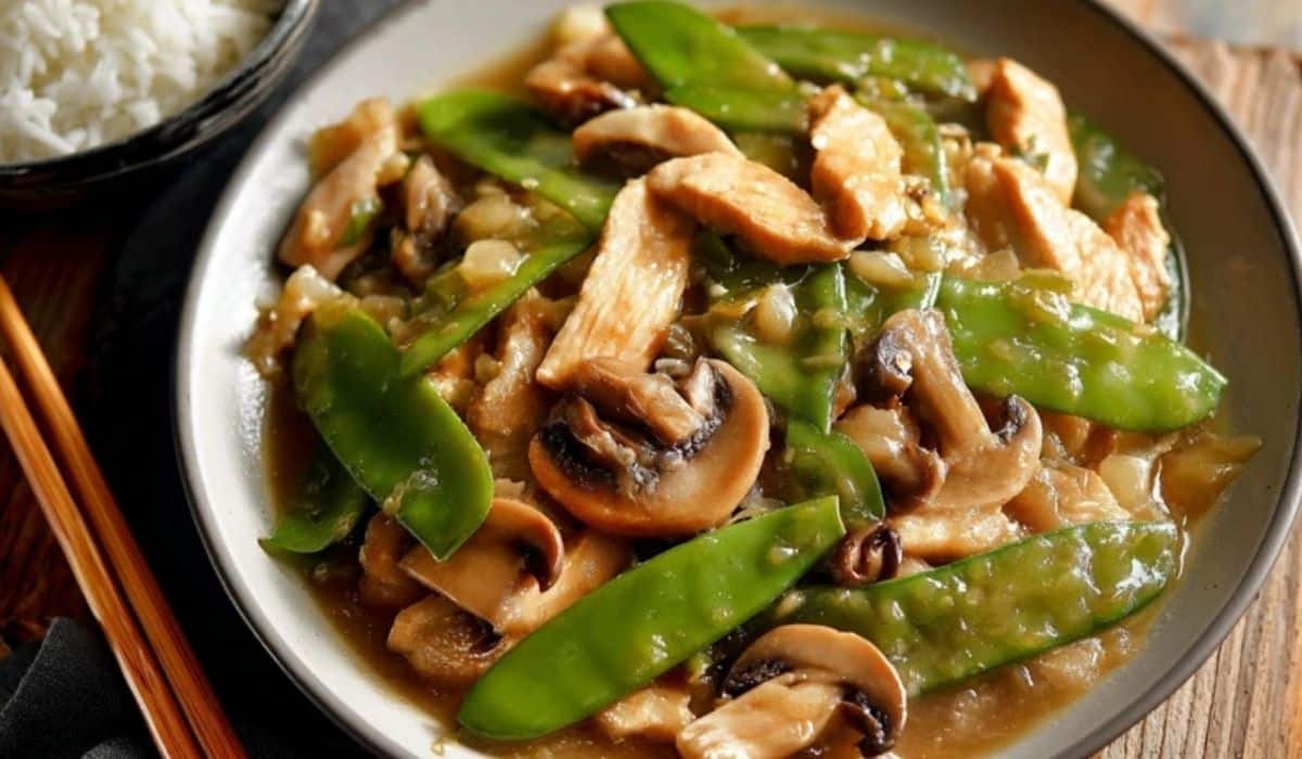 The Best Moo Goo Gai Pan served in white bowl with mushrooms and snow peas