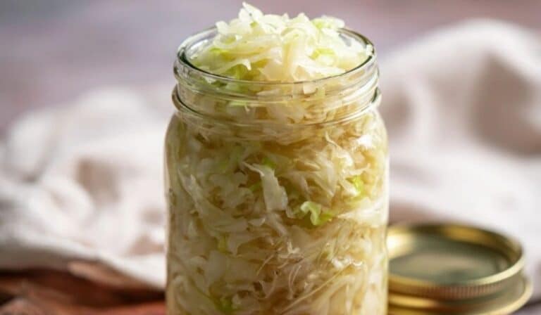 5-day homemade sauerkraut in a glass jar with crisp tangy cabbage