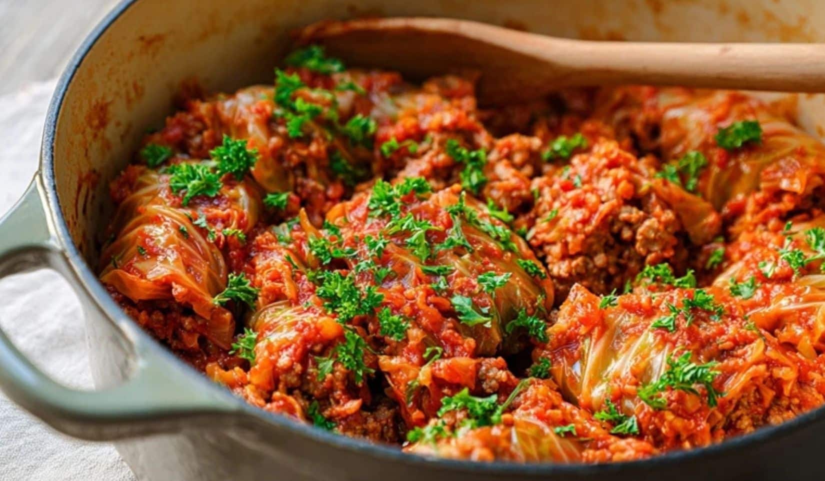One Pot Crazy Cabbage Rolls in a Dutch oven with tomato sauce and parsley